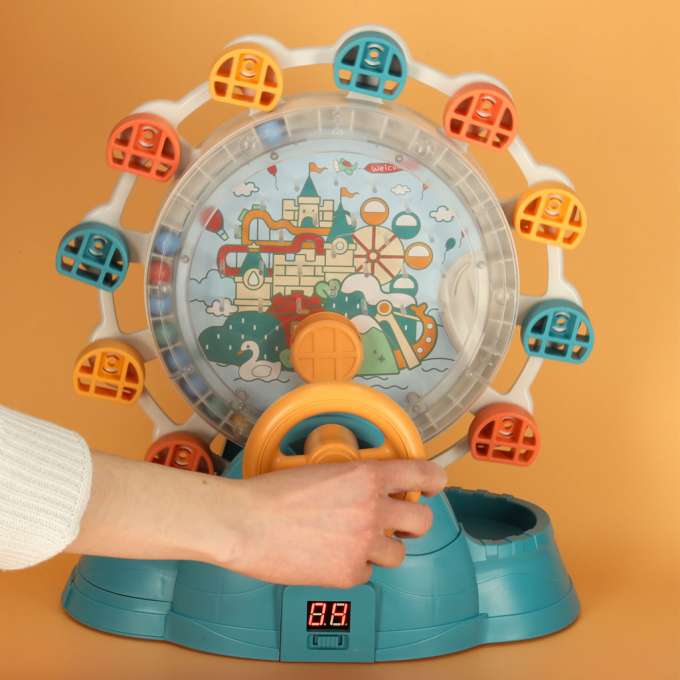 Ferris wheel carousel with steering wheel catching balls